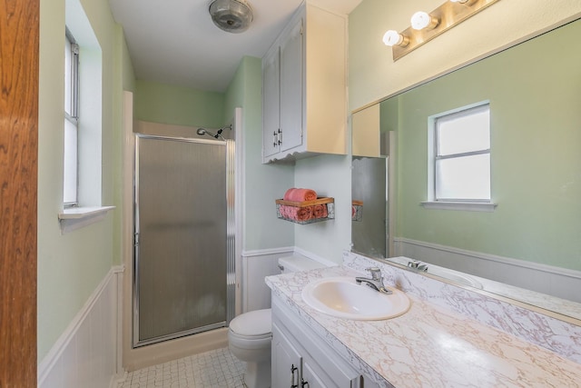 bathroom featuring vanity, toilet, and walk in shower