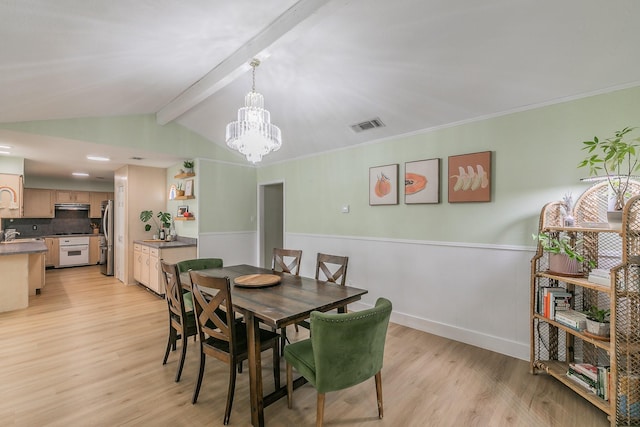 dining space featuring an inviting chandelier, crown molding, lofted ceiling with beams, and light wood-type flooring