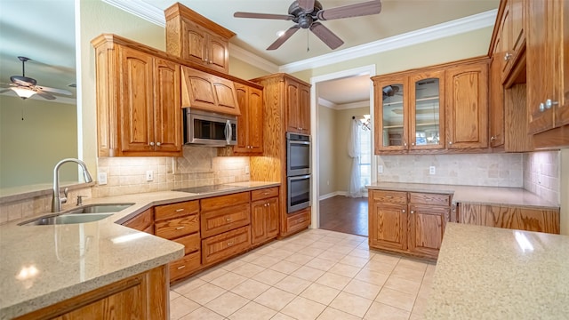 kitchen featuring light tile patterned flooring, appliances with stainless steel finishes, sink, backsplash, and ornamental molding