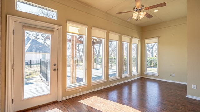 doorway to outside featuring crown molding, ceiling fan, and dark hardwood / wood-style flooring