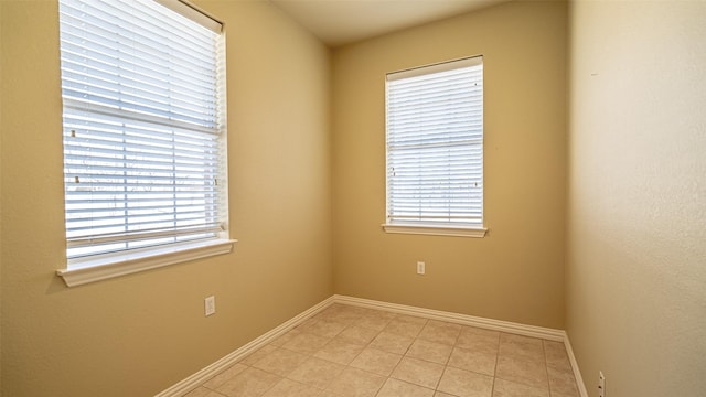 tiled empty room featuring plenty of natural light