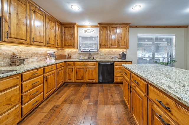 kitchen with dishwasher, sink, dark hardwood / wood-style flooring, decorative backsplash, and light stone counters