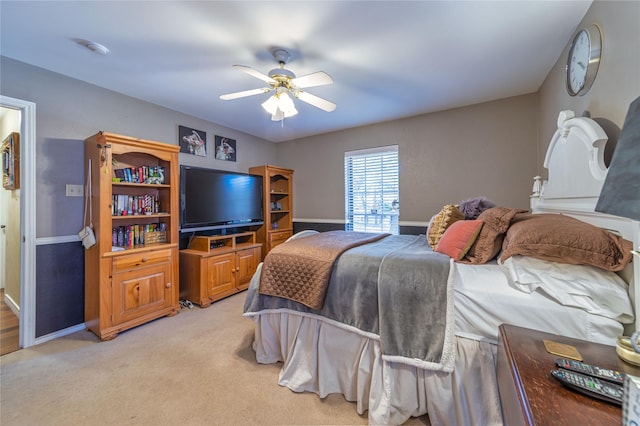 bedroom featuring light carpet and ceiling fan