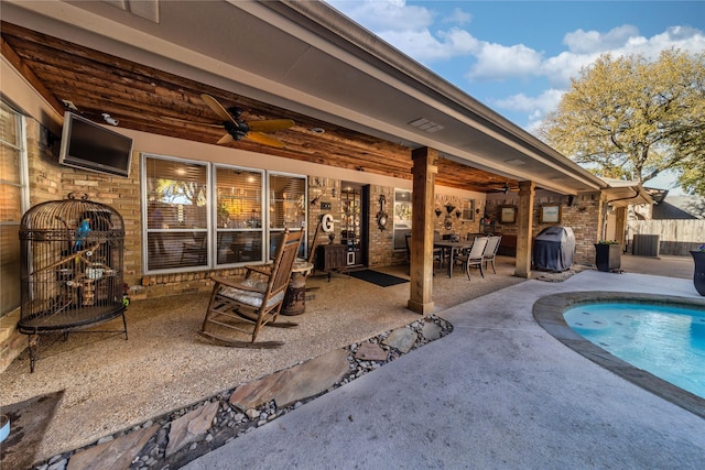 view of swimming pool with area for grilling, central air condition unit, ceiling fan, and a patio area