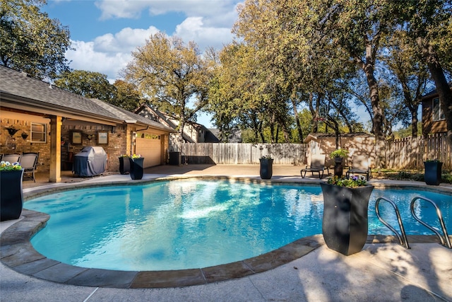 view of pool with cooling unit, a grill, and a patio