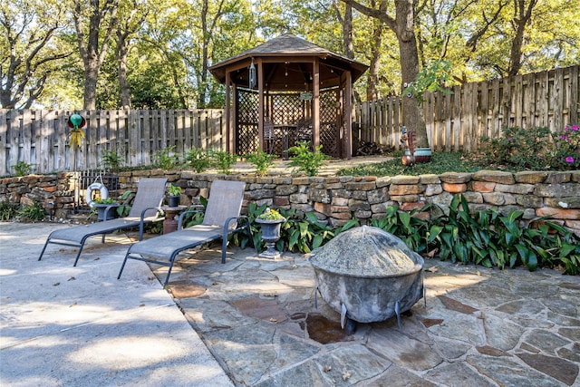 view of patio / terrace with a gazebo and a fire pit