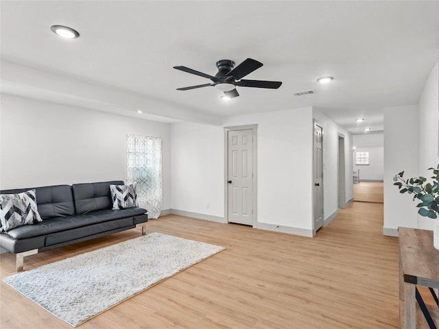 living room with ceiling fan, light hardwood / wood-style floors, and a healthy amount of sunlight