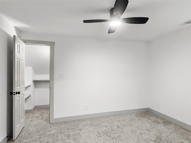 empty room featuring light colored carpet and ceiling fan