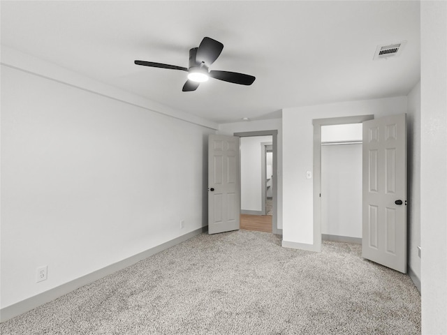 unfurnished bedroom with carpet floors, a closet, and ceiling fan