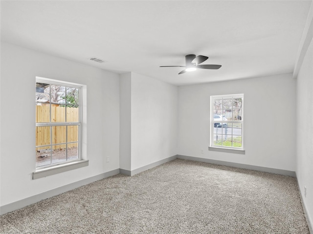 carpeted empty room featuring ceiling fan