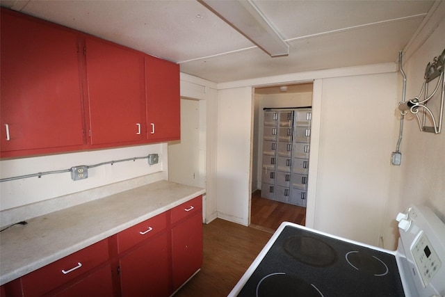 kitchen featuring dark hardwood / wood-style floors and electric stove