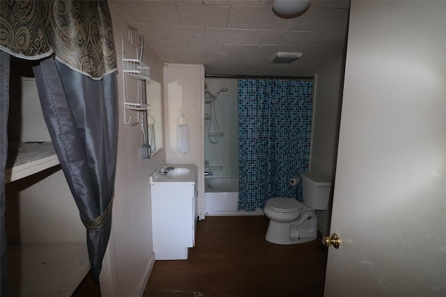 full bathroom featuring wood-type flooring, vanity, shower / tub combo, and toilet