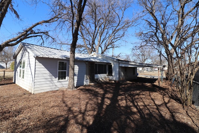 back of property with a carport