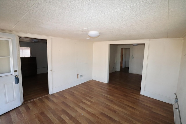 unfurnished room featuring dark wood-type flooring