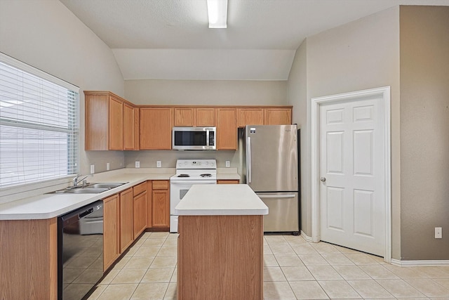 kitchen featuring light tile patterned flooring, lofted ceiling, sink, appliances with stainless steel finishes, and a kitchen island