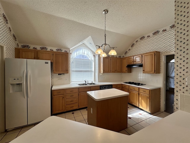 kitchen with vaulted ceiling, sink, hanging light fixtures, a center island, and black appliances