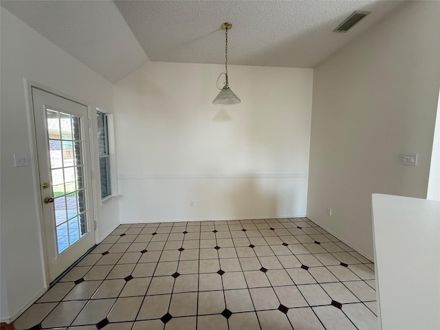 2414 W Stillwater Dr, Mesquite, TX 75181 - unfurnished dining area with light flooring, a textured ceiling, and vaulted ceiling