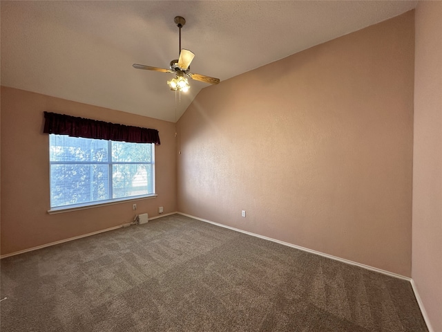 carpeted empty room featuring vaulted ceiling and ceiling fan