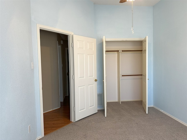 unfurnished bedroom with light colored carpet and a closet