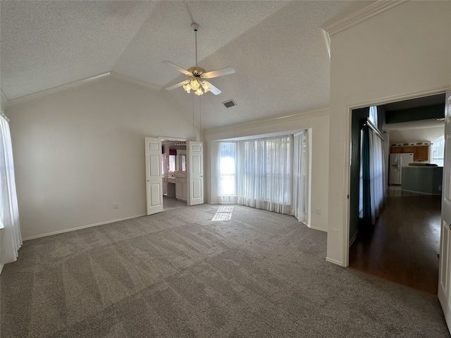 unfurnished living room with crown molding, vaulted ceiling, a textured ceiling, ceiling fan, and carpet