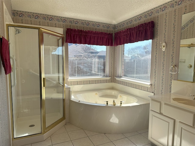 bathroom with tile patterned floors, shower with separate bathtub, a textured ceiling, and vanity