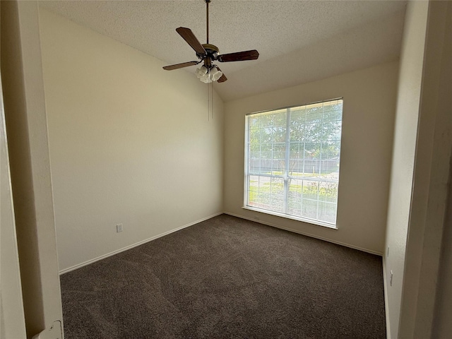 2414 W Stillwater Dr, Mesquite, TX 75181 - spare room with dark colored carpet, a textured ceiling, vaulted ceiling, and ceiling fan