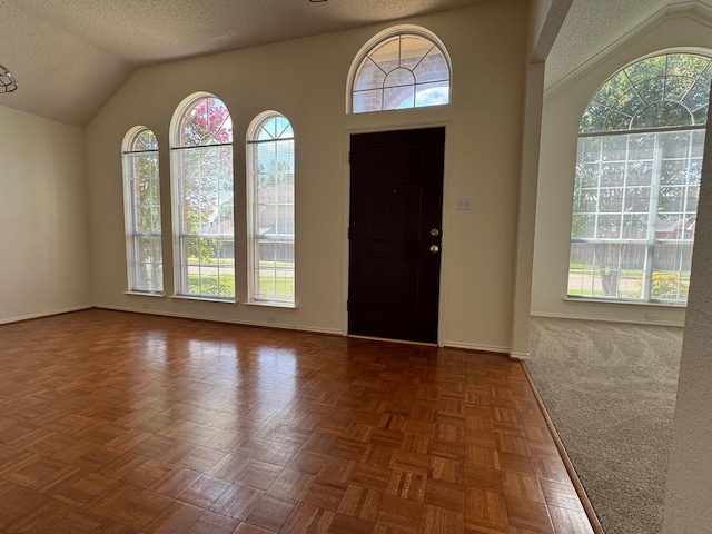 2414 W Stillwater Dr, Mesquite, TX 75181 - entryway featuring healthy amount of natural light, a textured ceiling, and lofted ceiling