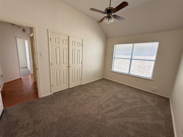 2414 W Stillwater Dr, Mesquite, TX 75181 - unfurnished bedroom featuring dark carpet, lofted ceiling, a closet, and a ceiling fan