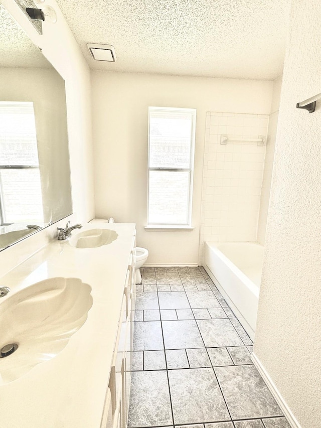 2414 W Stillwater Dr, Mesquite, TX 75181 - full bath featuring a textured ceiling, double vanity, and shower / bathtub combination