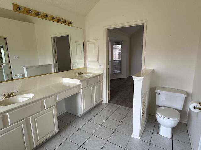 2414 W Stillwater Dr, Mesquite, TX 75181 - bathroom featuring vaulted ceiling, double vanity, and tile patterned flooring