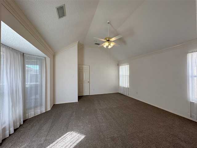 carpeted spare room with lofted ceiling, ceiling fan, ornamental molding, and a textured ceiling