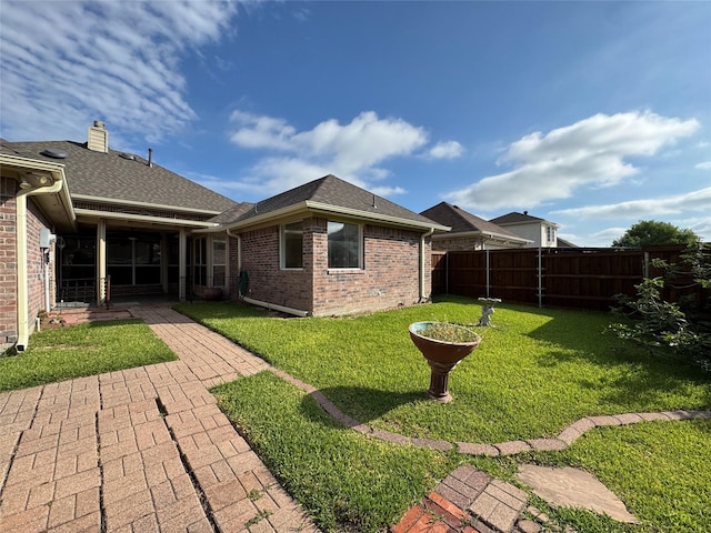 2414 W Stillwater Dr, Mesquite, TX 75181 - back of house with a fenced backyard, a patio area, brick siding, and roof with shingles