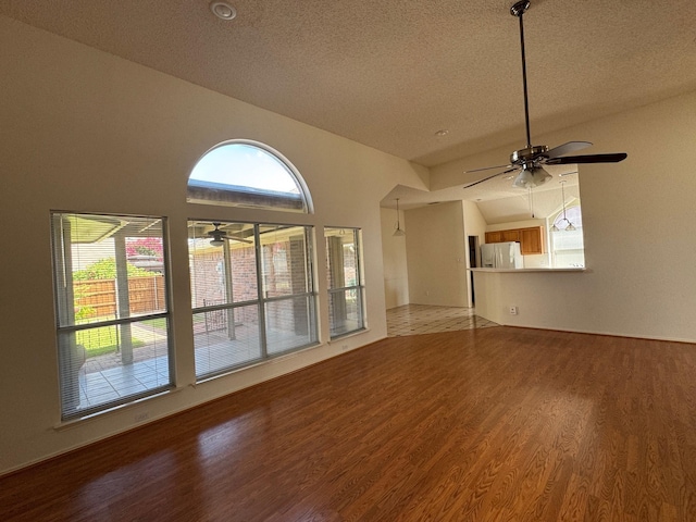 2414 W Stillwater Dr, Mesquite, TX 75181 - unfurnished room featuring wood finished floors, plenty of natural light, a textured ceiling, and ceiling fan