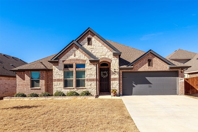 view of front of home with a garage and a front yard