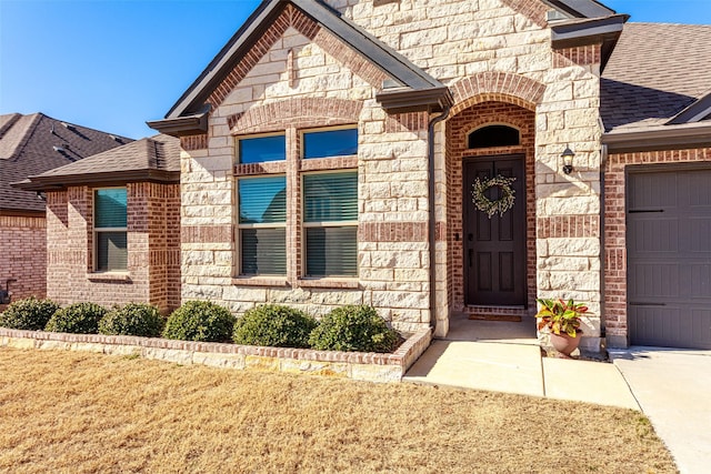 doorway to property with a garage