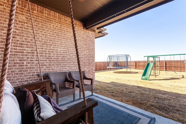 view of patio / terrace with a trampoline and a playground