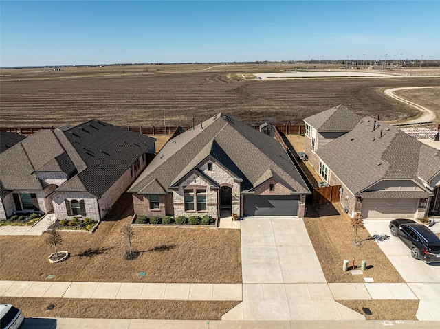 birds eye view of property with a rural view