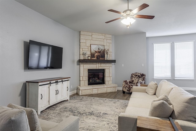 living room featuring ceiling fan, a fireplace, and hardwood / wood-style floors