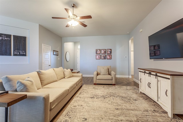 living room with ceiling fan and light hardwood / wood-style floors