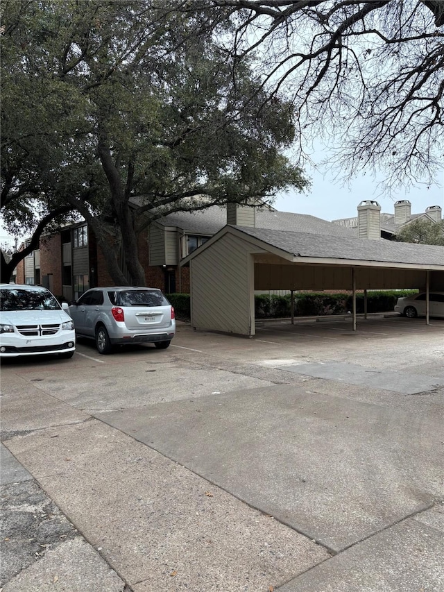 view of vehicle parking with a carport