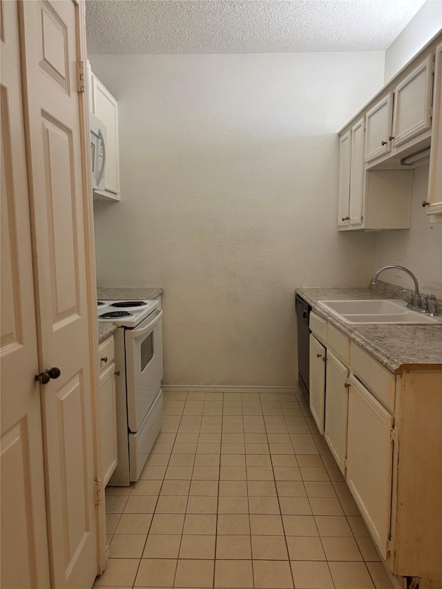 kitchen with sink, white appliances, light tile patterned floors, and a textured ceiling