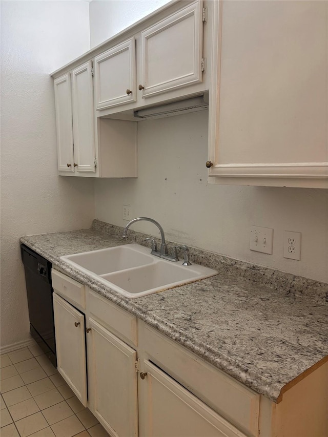 kitchen with white cabinetry, light tile patterned flooring, black dishwasher, and sink