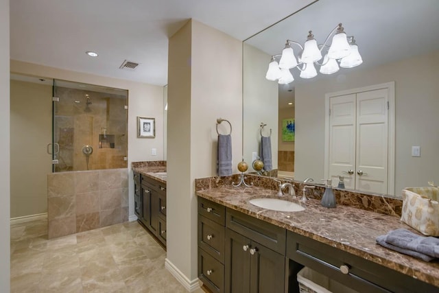 bathroom featuring vanity and a shower with shower door