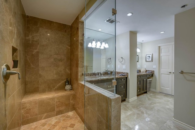 bathroom with vanity and a tile shower