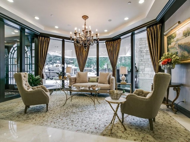 sitting room featuring a notable chandelier and a raised ceiling