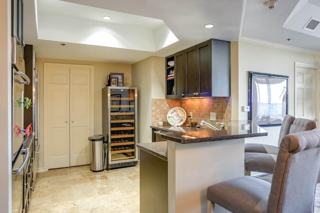 bar featuring wine cooler, dark brown cabinetry, dark stone countertops, ornamental molding, and backsplash