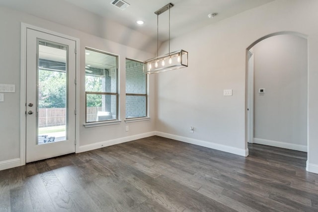 unfurnished dining area with a healthy amount of sunlight and dark hardwood / wood-style floors