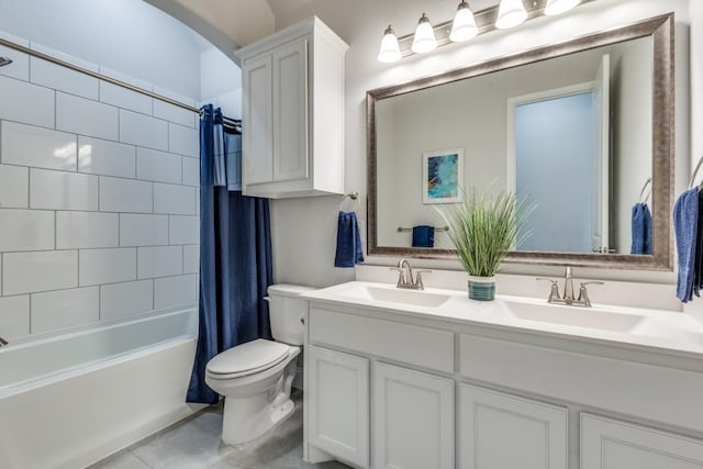 full bathroom featuring vanity, tile patterned floors, toilet, and shower / bath combo with shower curtain