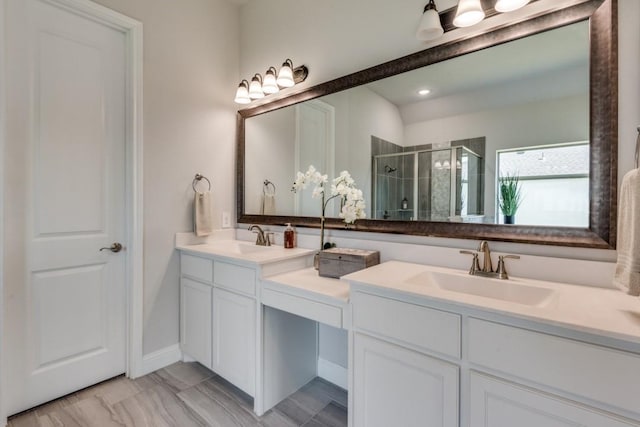 bathroom with vanity and a shower with shower door