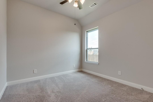 carpeted spare room featuring lofted ceiling and ceiling fan